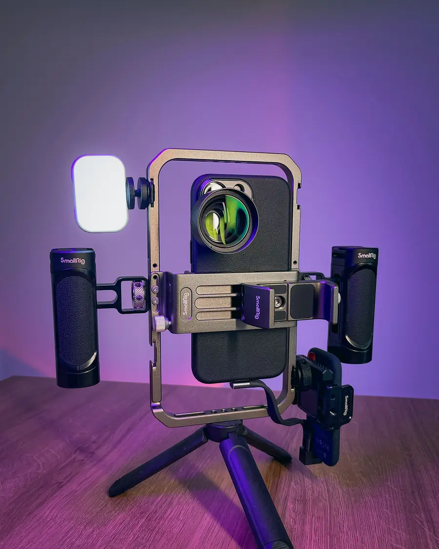A phone on a filming rig with a light, ready to go live.
