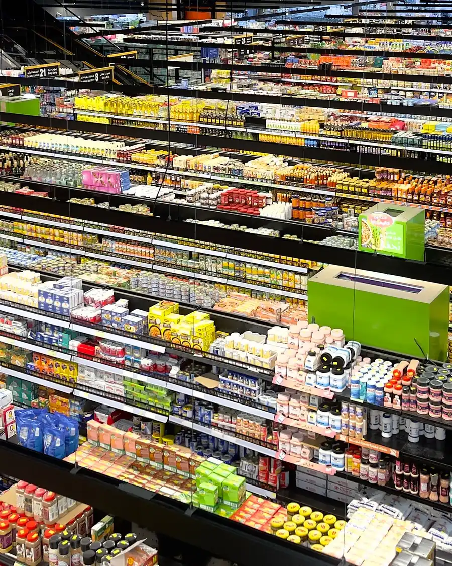 Supermarket aisles packed with products, seen from above.